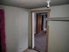 a view of a livingroom with an empty space and a window