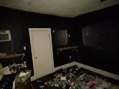 a view of a room with a ceiling fan and window