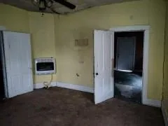 a view of an empty room with a kitchen