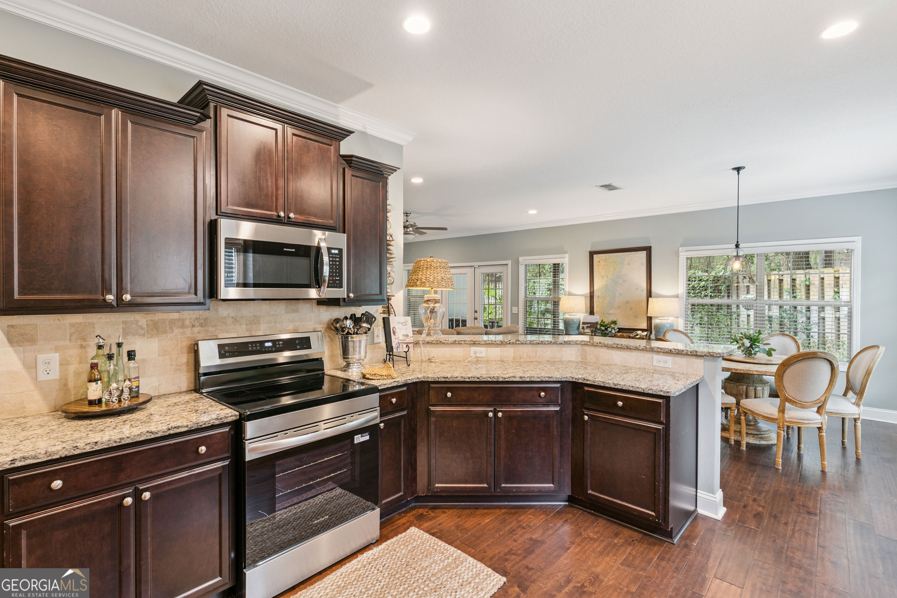 41 Simonton Lane St. Simons Island, GA 31522 - Photo 11 of 28 a kitchen with granite countertop a stove top oven sink and cabinets