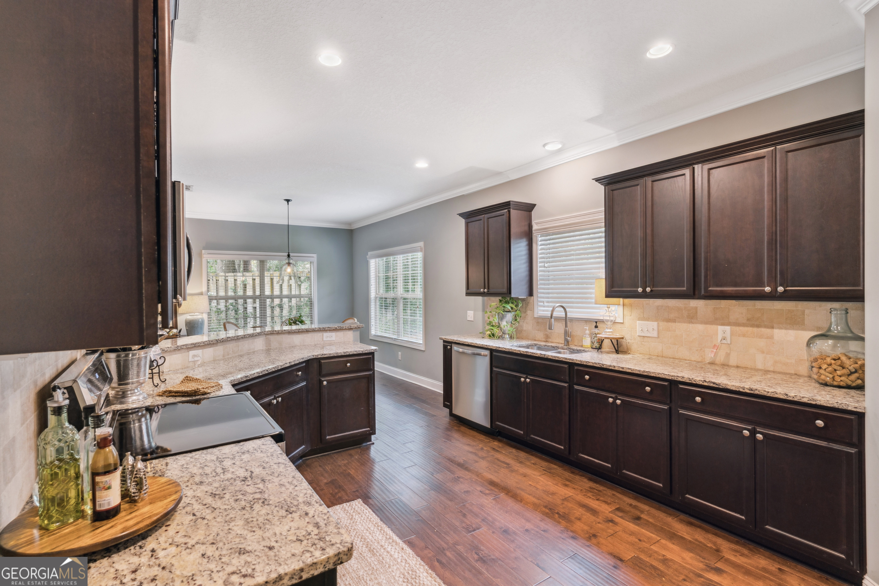 41 Simonton Lane St. Simons Island, GA 31522 - Photo 12 of 28 a large kitchen with stainless steel appliances granite countertop a sink and wooden cabinets