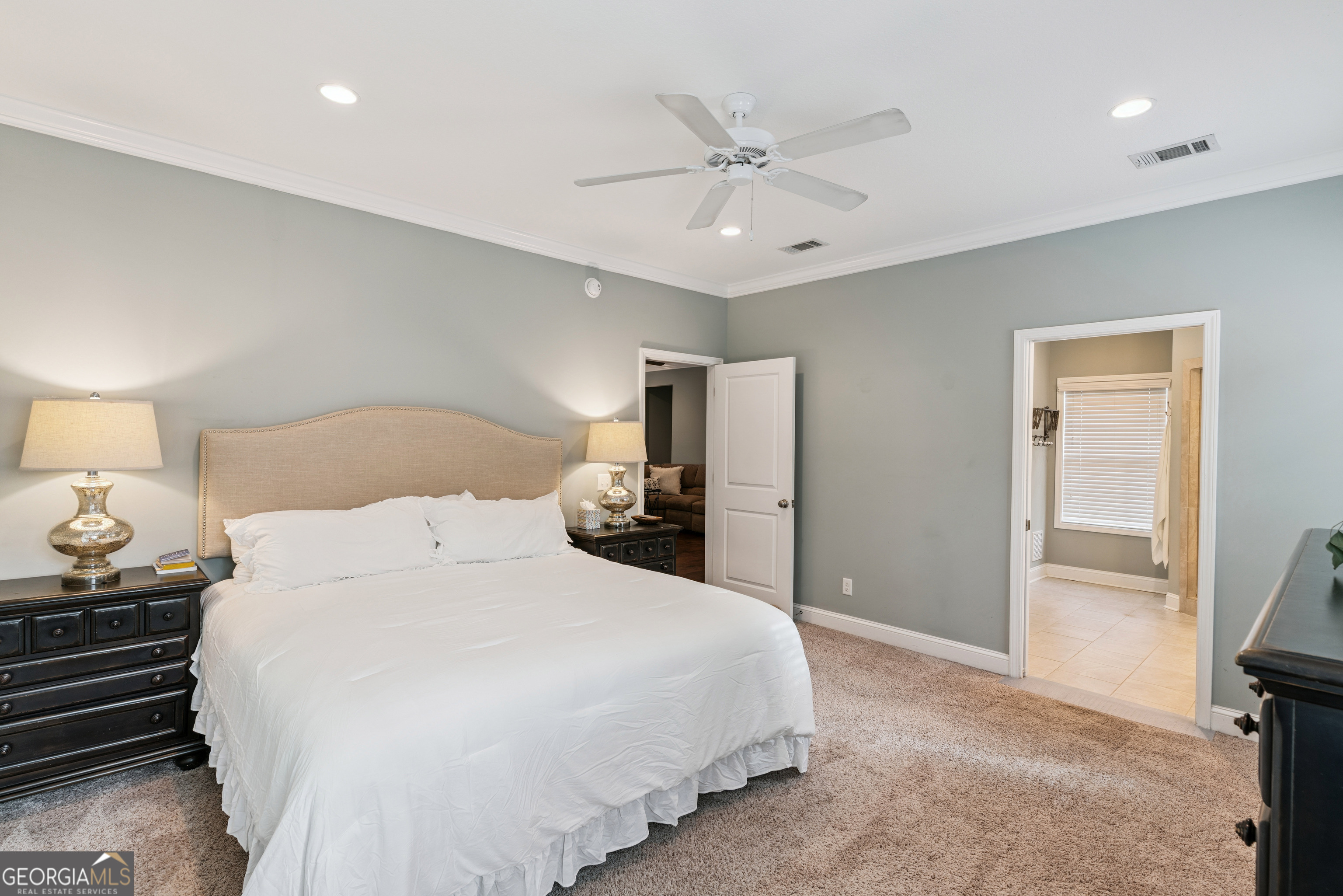 41 Simonton Lane St. Simons Island, GA 31522 - Photo 15 of 28 a bedroom with a bed and a chandelier