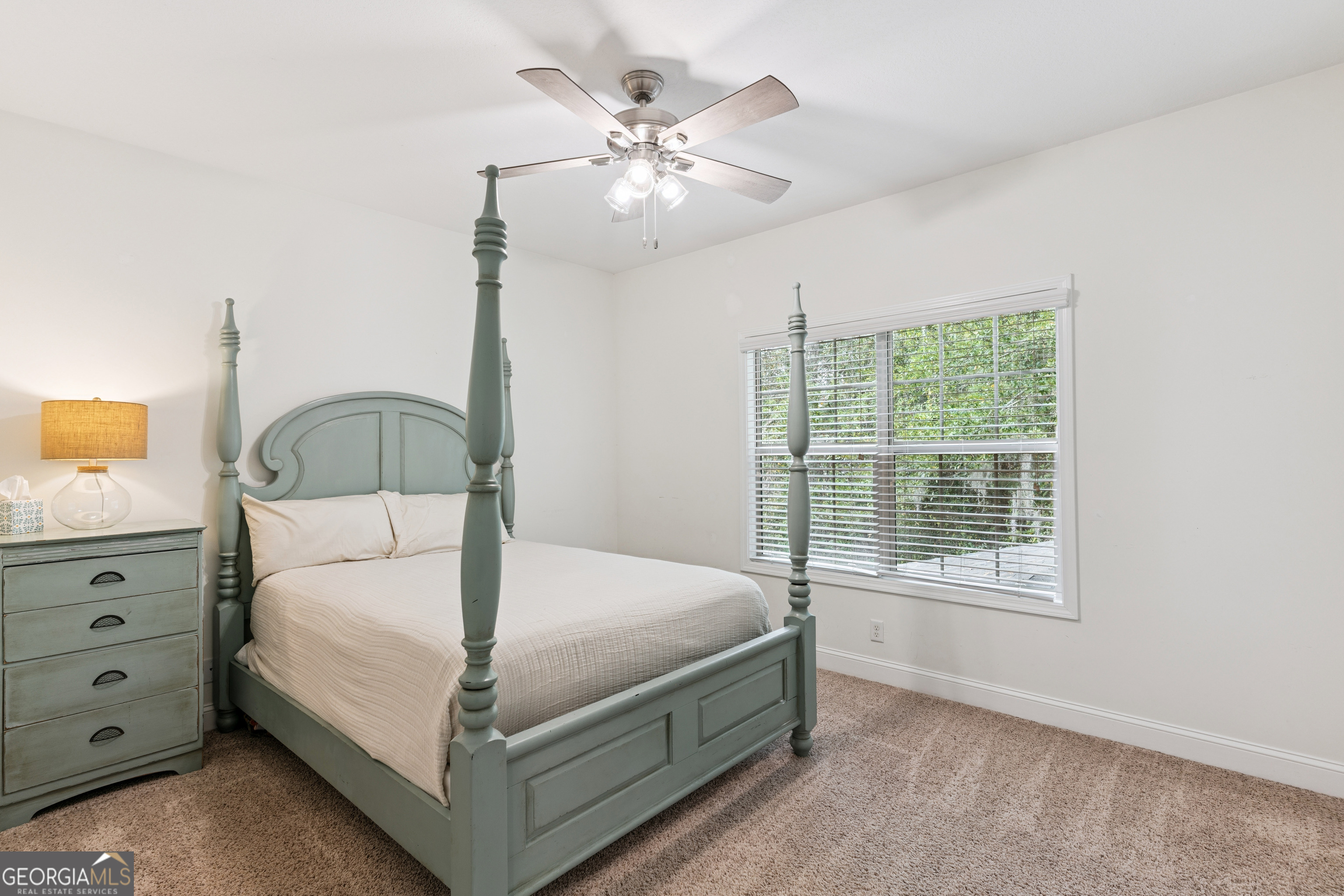 41 Simonton Lane St. Simons Island, GA 31522 - Photo 20 of 28 a bedroom with a bed a window and a chandelier