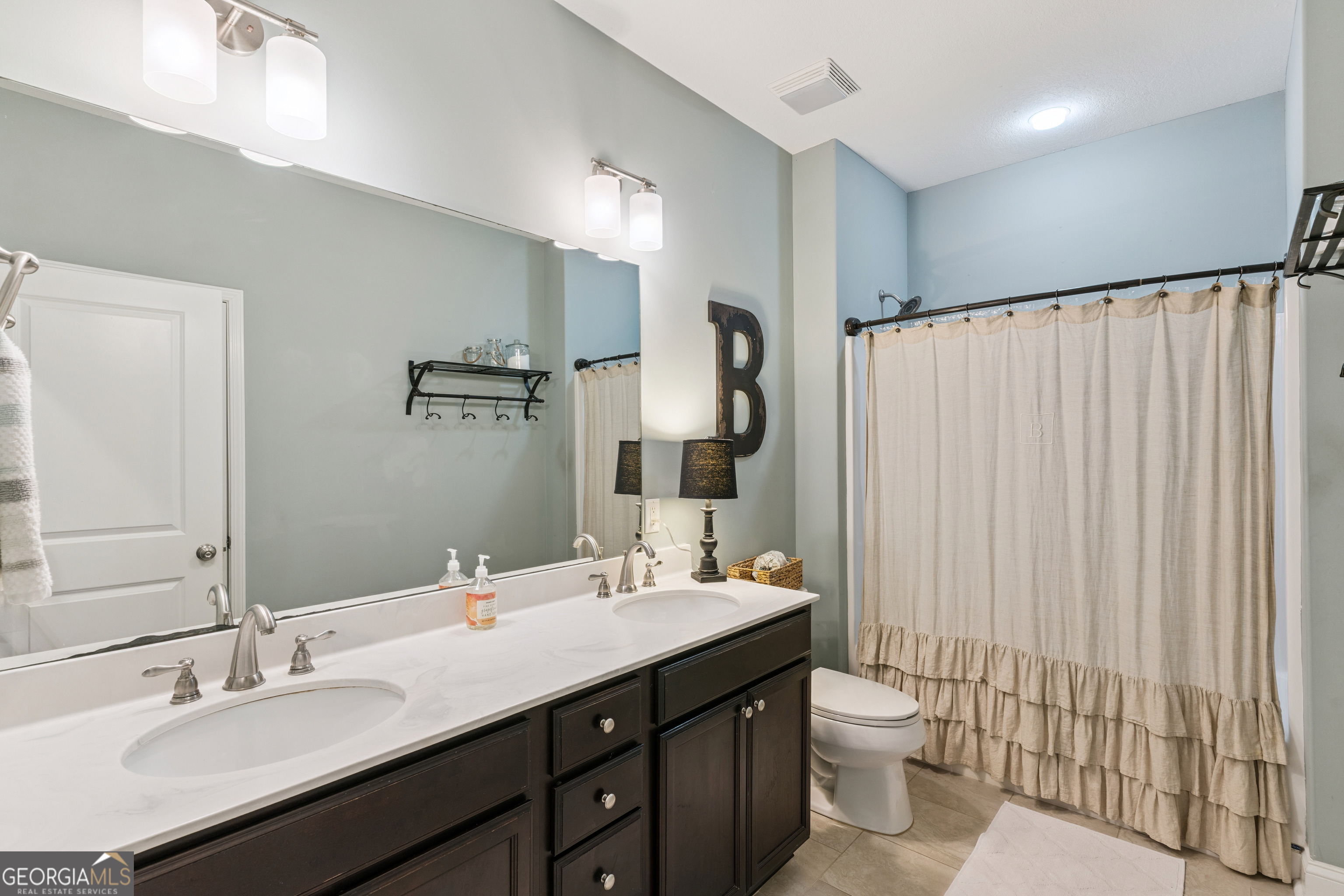 41 Simonton Lane St. Simons Island, GA 31522 - Photo 23 of 28 a bathroom with a double vanity sink mirror and toilet