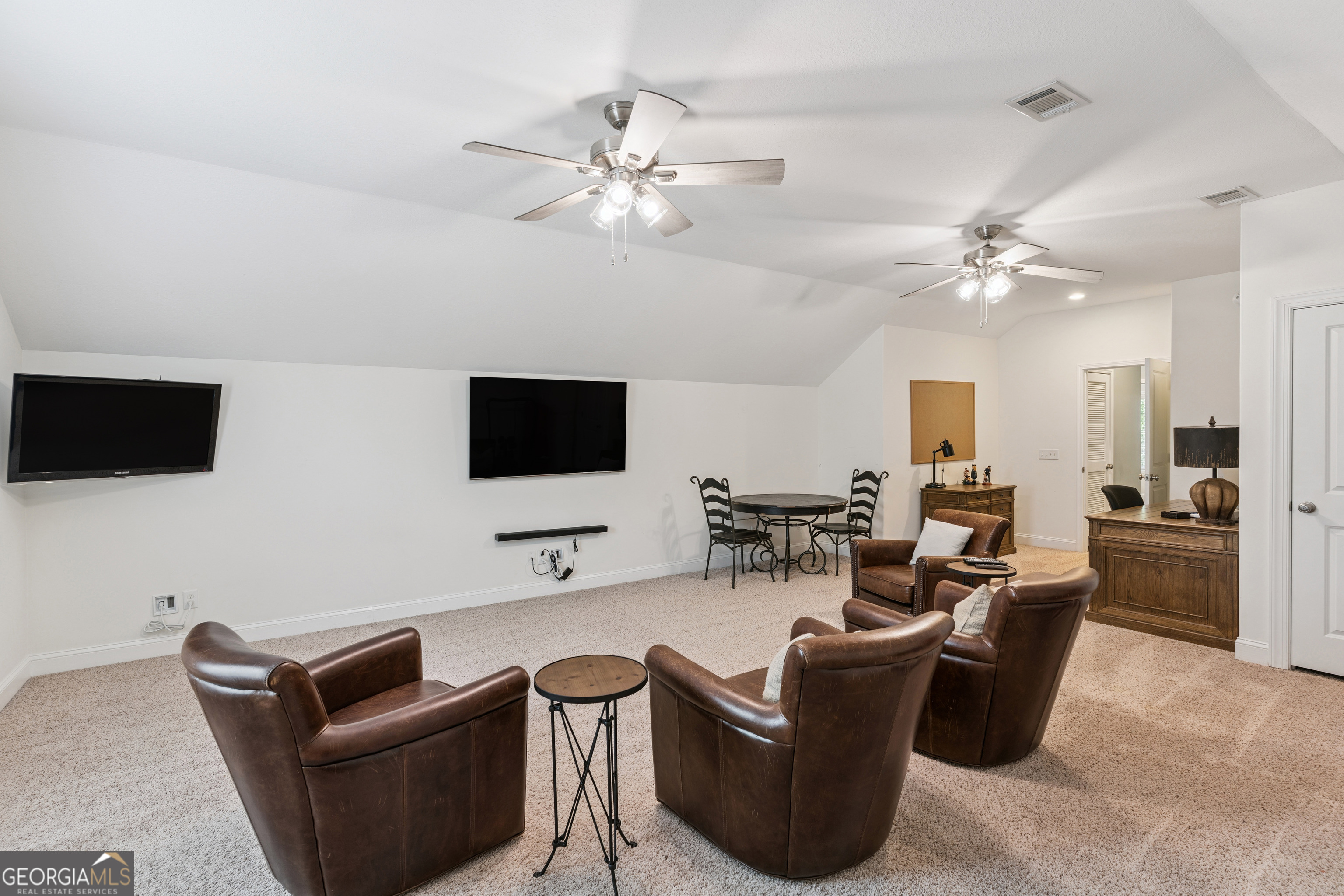 41 Simonton Lane St. Simons Island, GA 31522 - Photo 25 of 28 a living room with furniture a flat screen tv and kitchen view