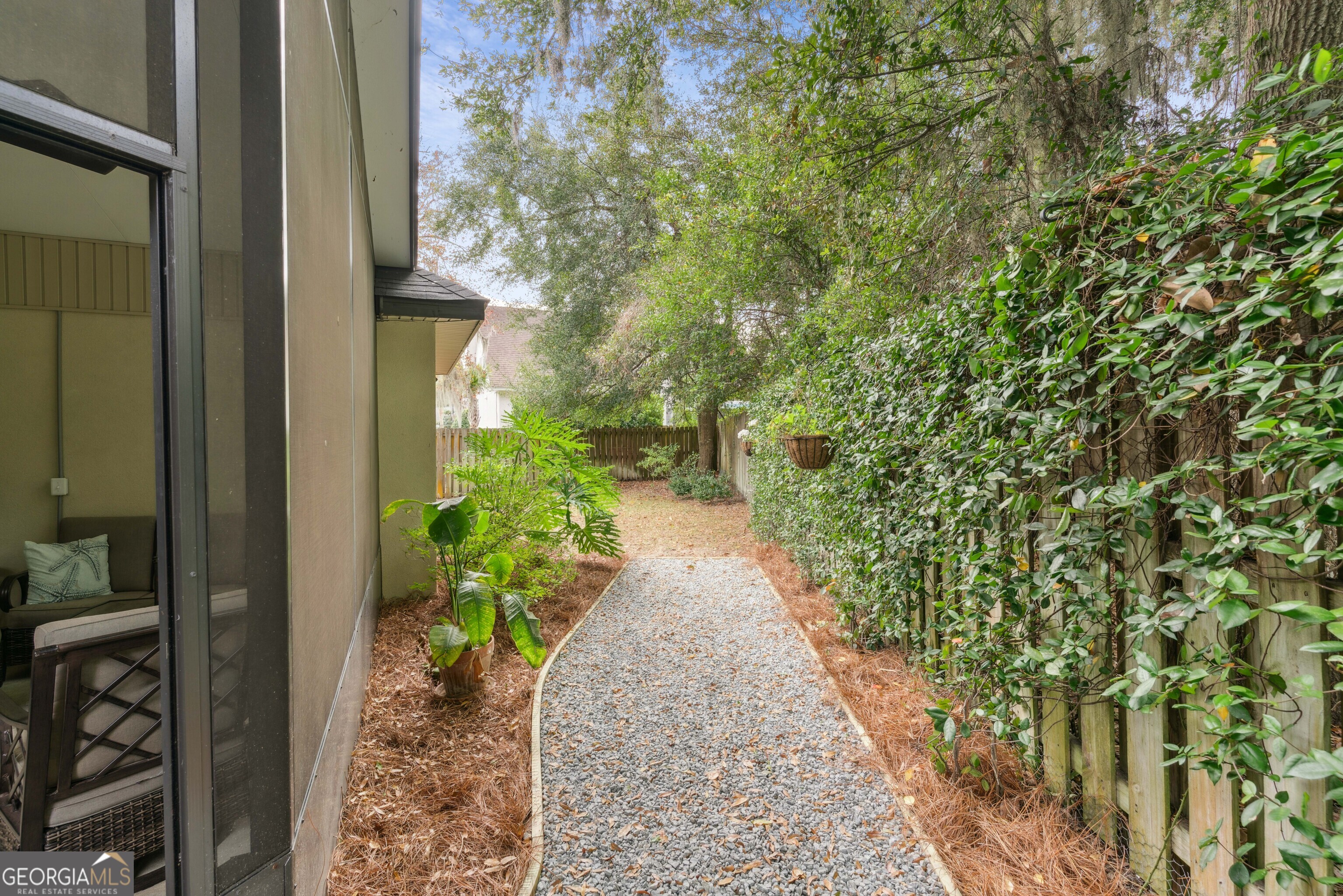 41 Simonton Lane St. Simons Island, GA 31522 - Photo 26 of 28 a entryway with flower plants in front of main door