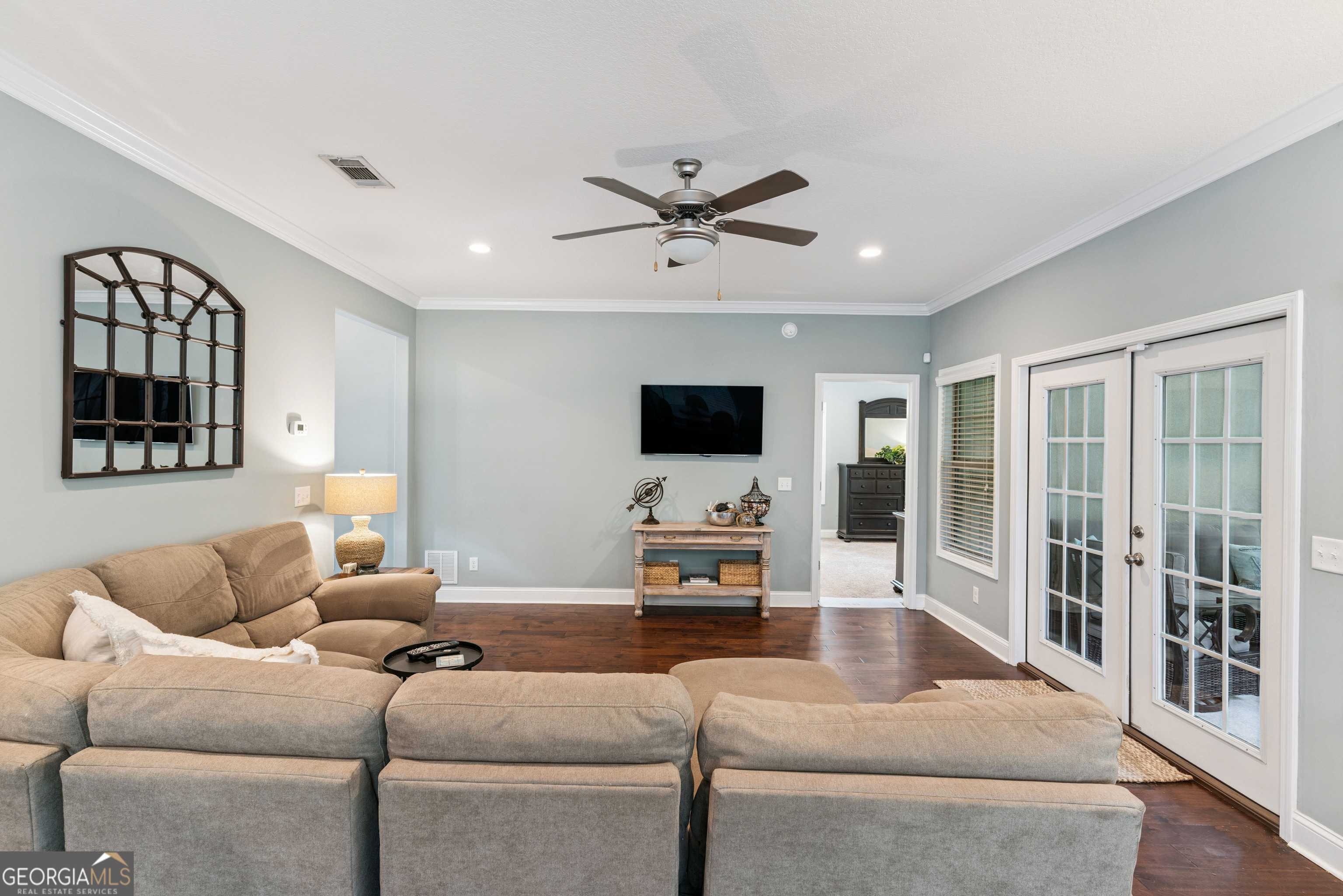 41 Simonton Lane St. Simons Island, GA 31522 - Photo 7 of 28 a living room with furniture ceiling fan and a flat screen tv