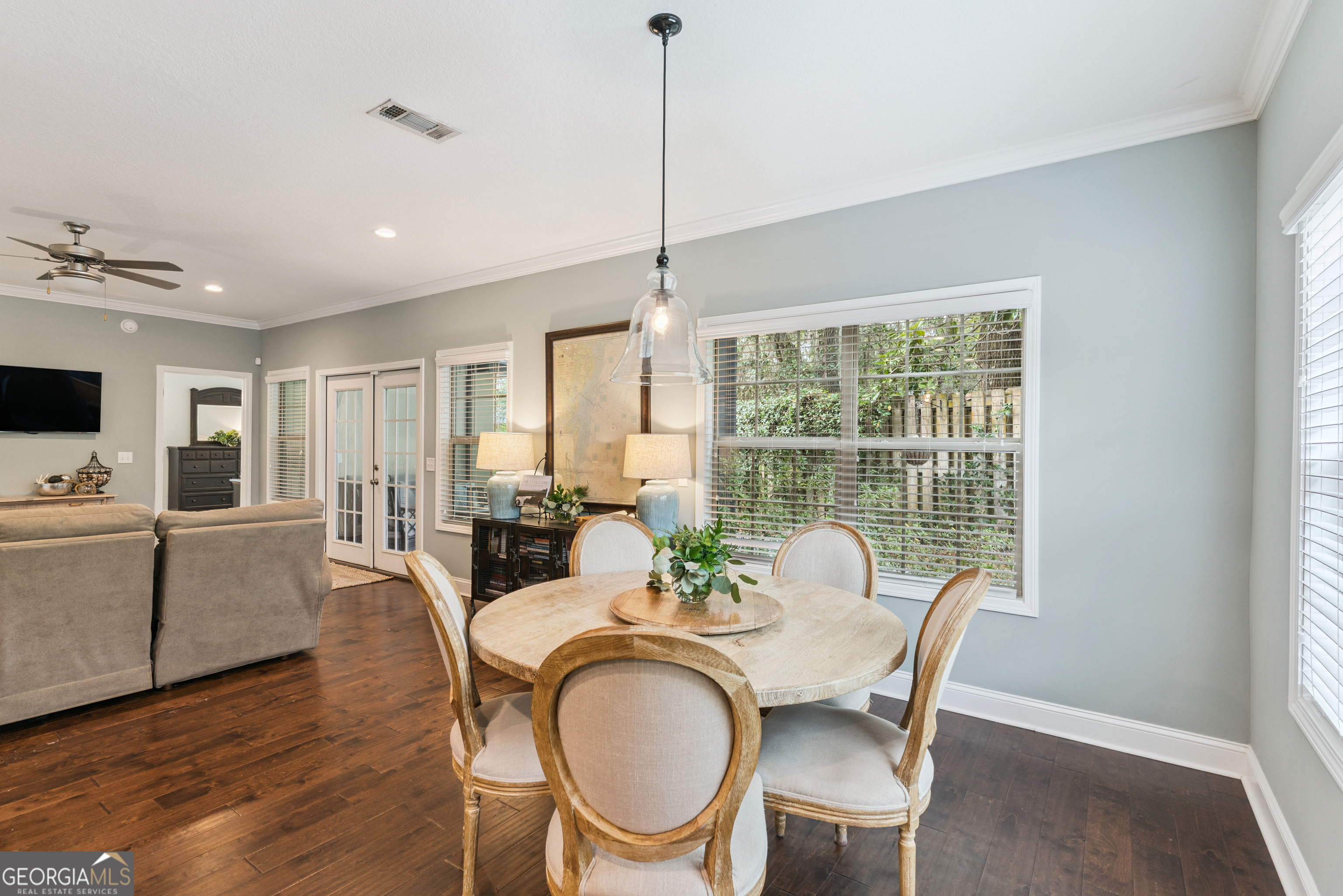 41 Simonton Lane St. Simons Island, GA 31522 - Photo 8 of 28 a dining room with furniture a chandelier and wooden floor