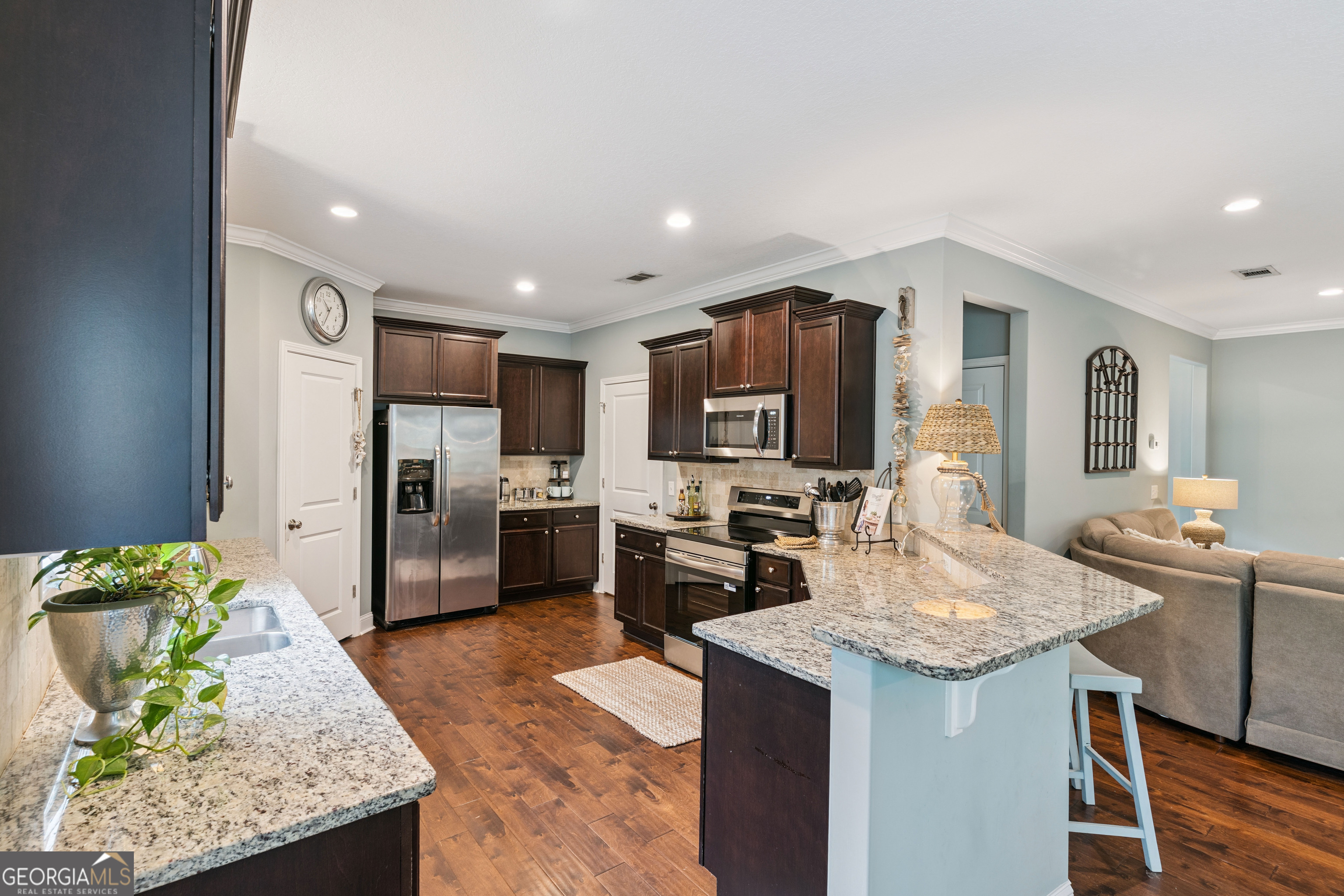 41 Simonton Lane St. Simons Island, GA 31522 - Photo 10 of 28 a kitchen with stainless steel appliances granite countertop a sink stove and refrigerator