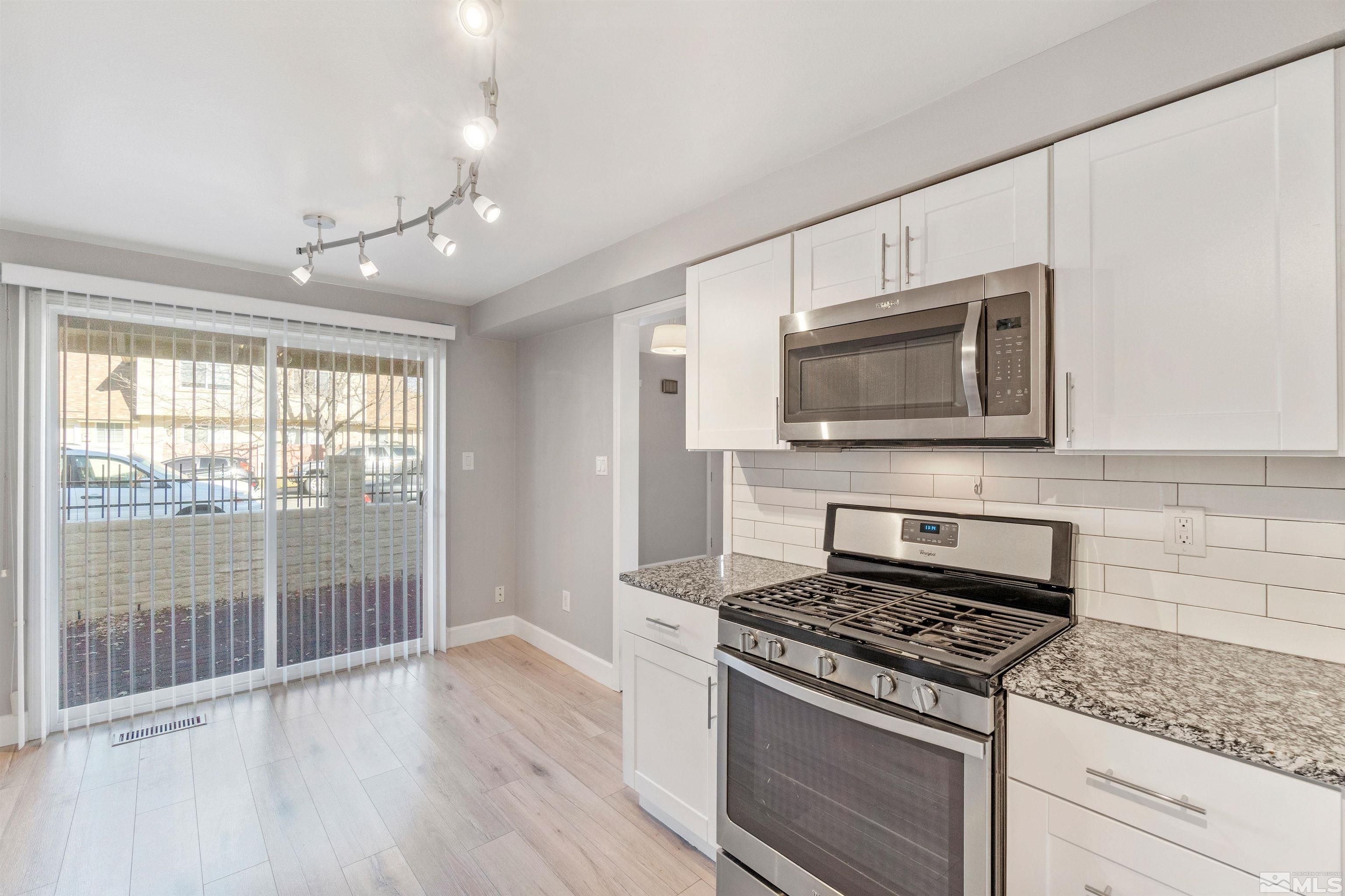 29 Condor Circle Carson City, NV 89701 - Photo 12 of 28 a kitchen with granite countertop a stove and a microwave