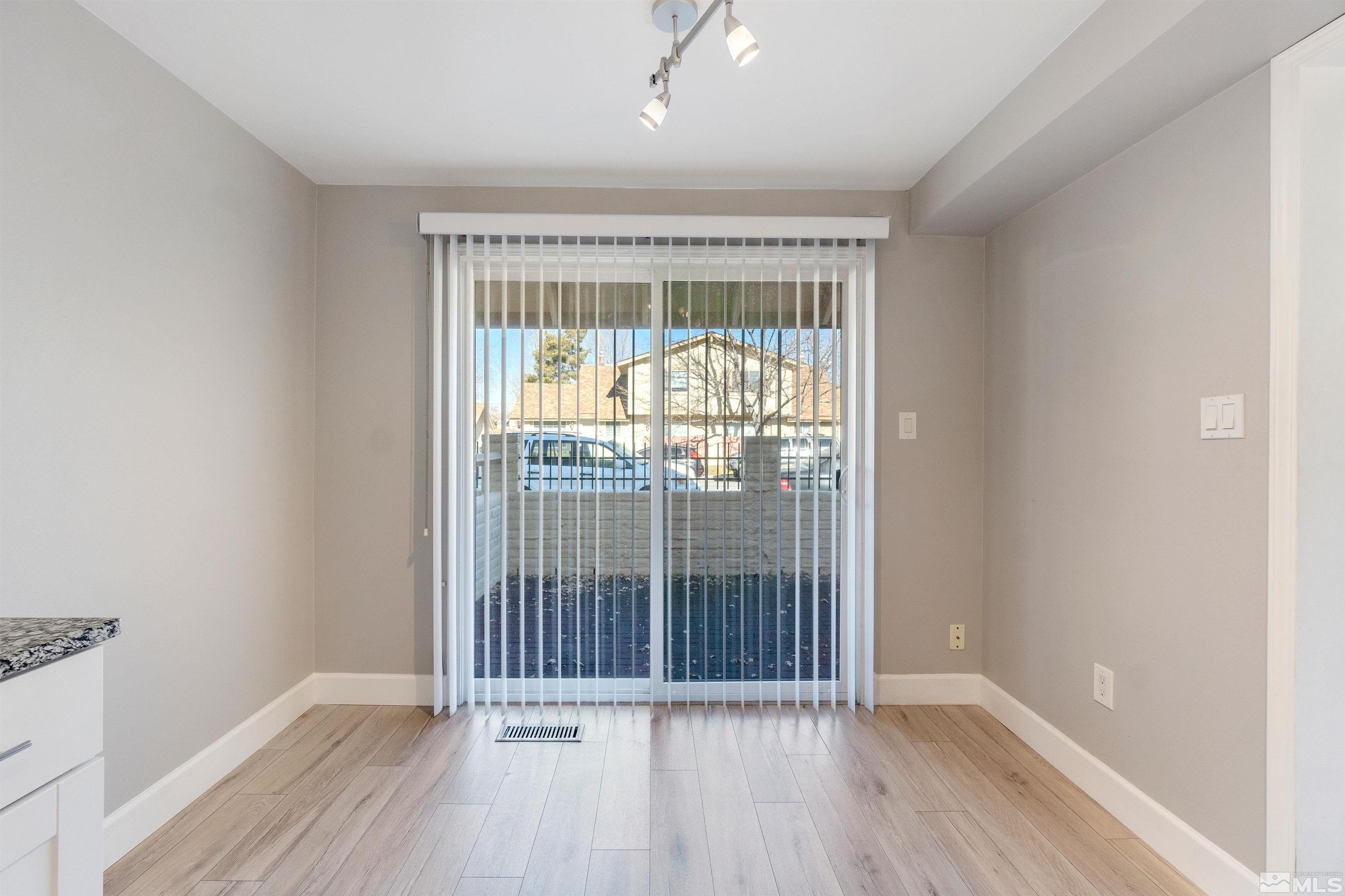 29 Condor Circle Carson City, NV 89701 - Photo 15 of 28 an empty room with wooden floor and windows