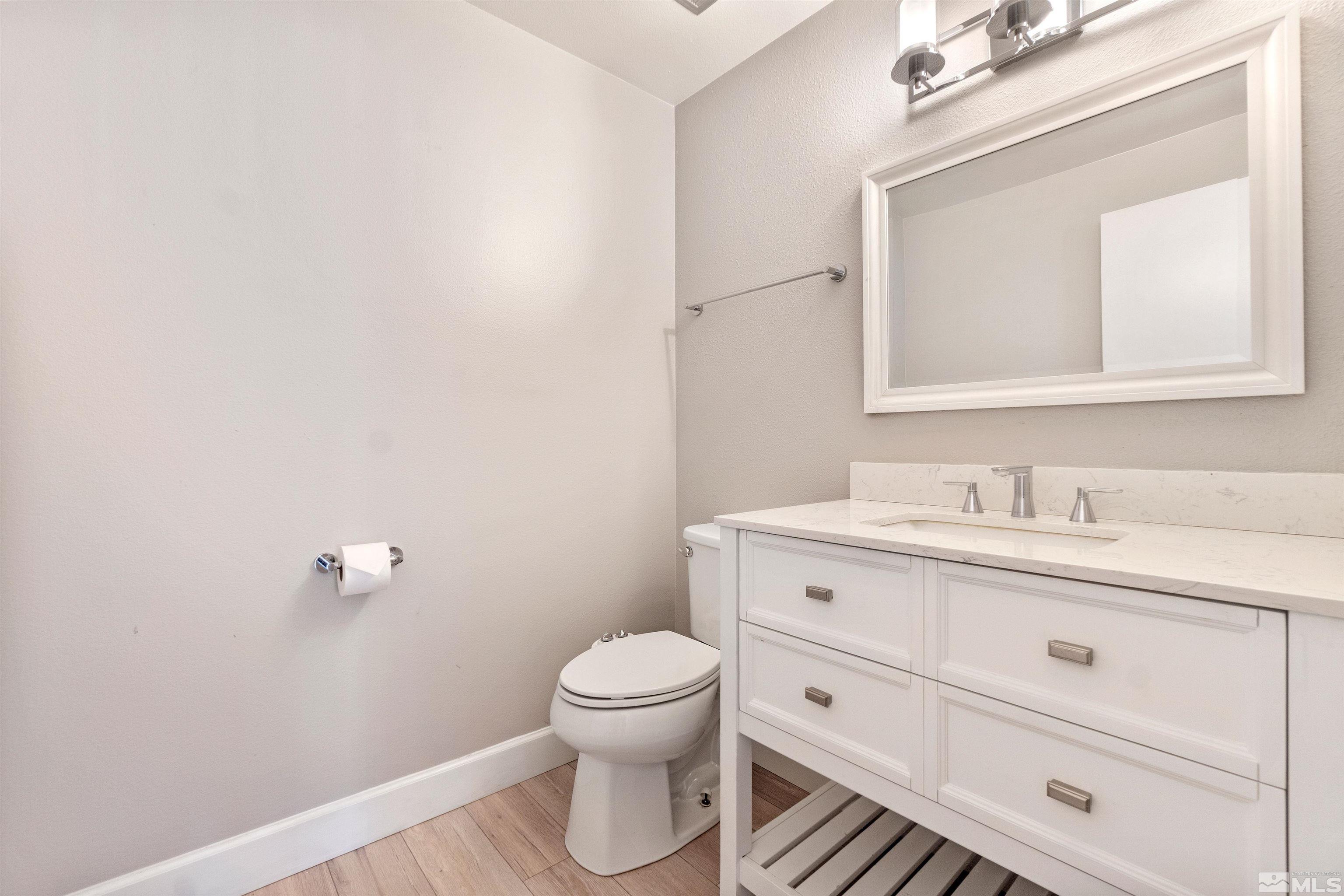 29 Condor Circle Carson City, NV 89701 - Photo 17 of 28 a bathroom with a toilet a sink a vanity and mirror