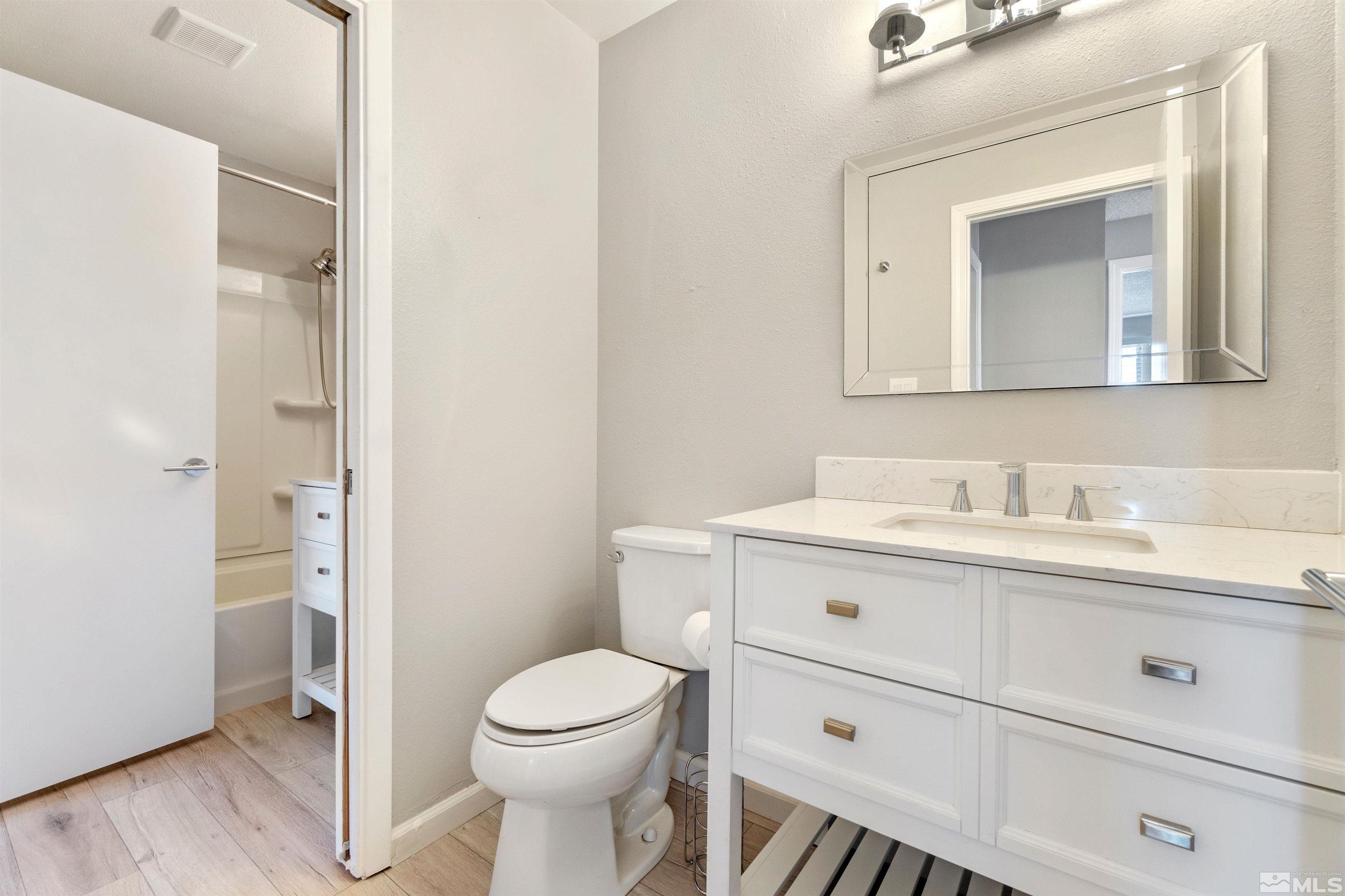 29 Condor Circle Carson City, NV 89701 - Photo 22 of 28 a bathroom with a toilet a sink a mirror and vanity