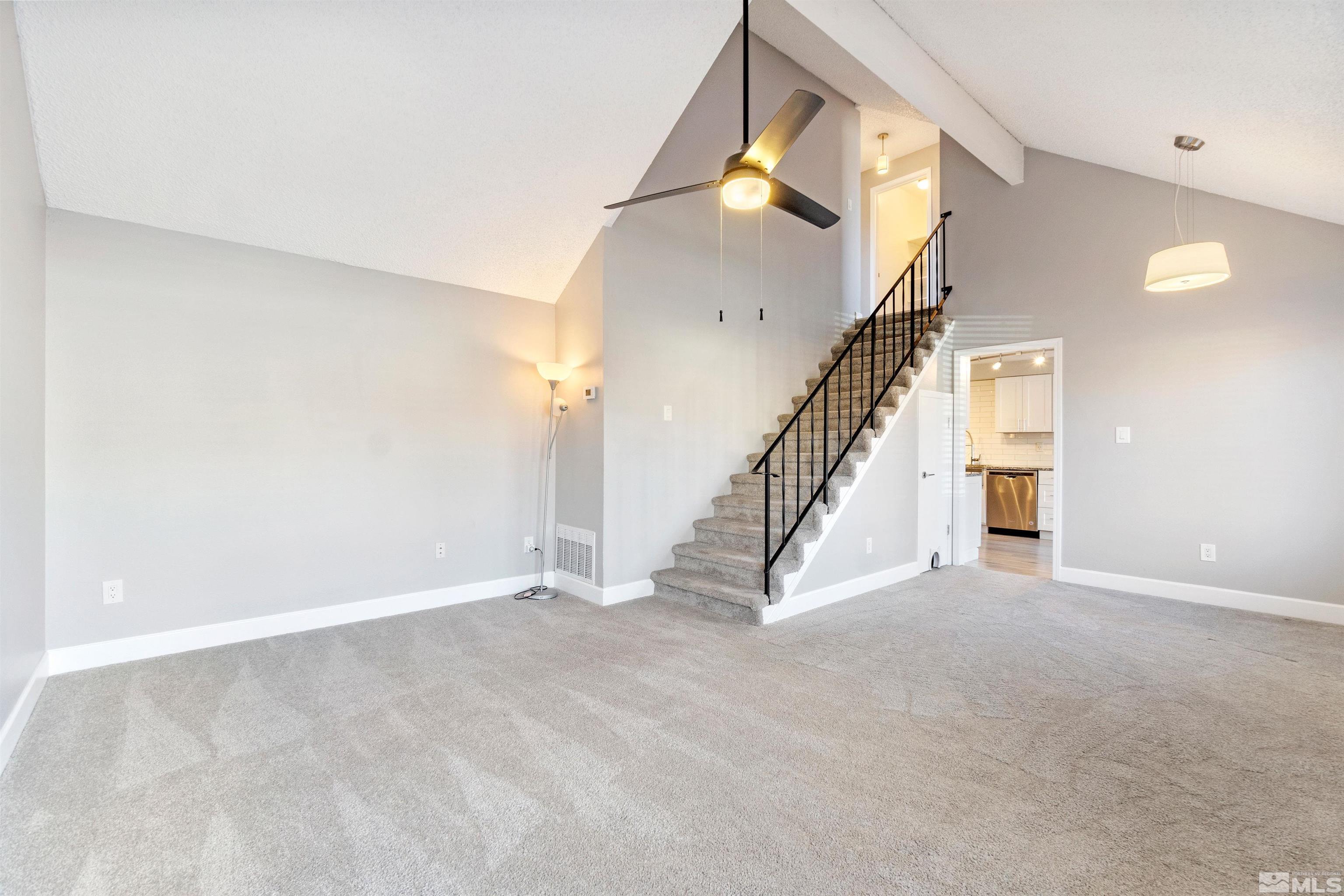 29 Condor Circle Carson City, NV 89701 - Photo 4 of 28 a view of an empty room with stairs and a living room view