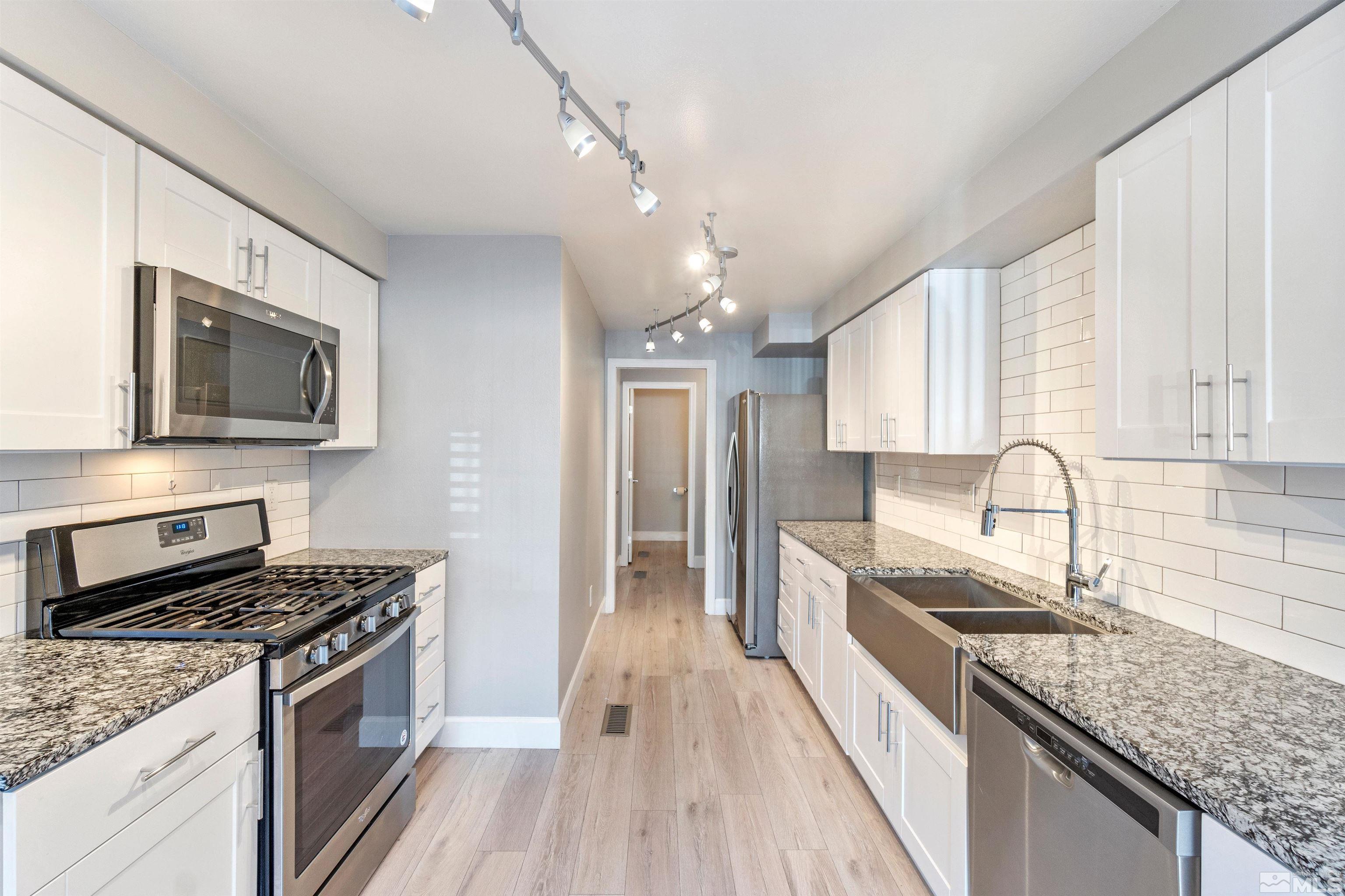 29 Condor Circle Carson City, NV 89701 - Photo 9 of 28 a kitchen with stainless steel appliances granite countertop a stove microwave and sink