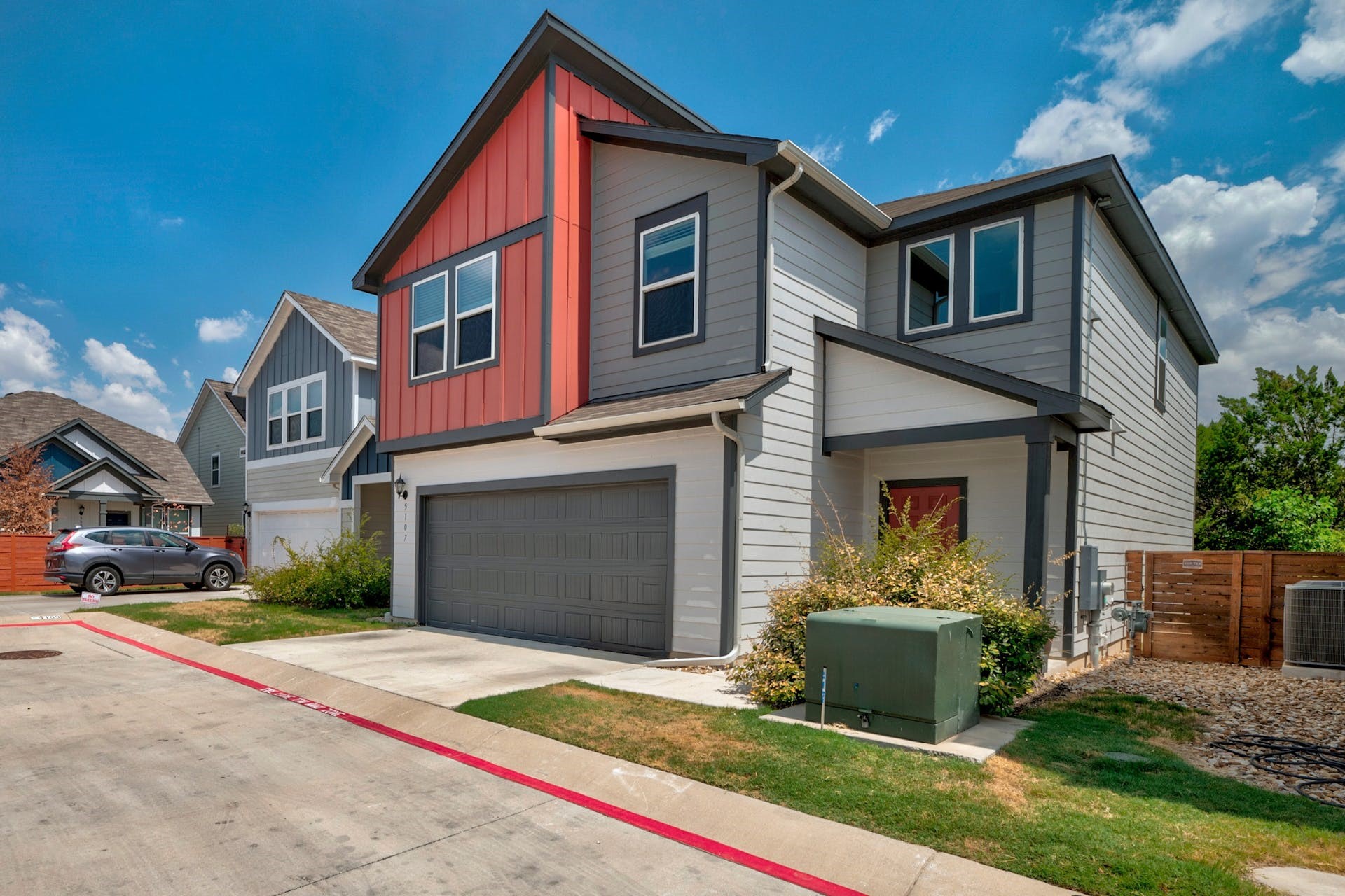 5107 Lemon Tree Path, Unit 127 Austin, TX 78723 - Photo 2 of 40 a front view of a house with a yard and garage