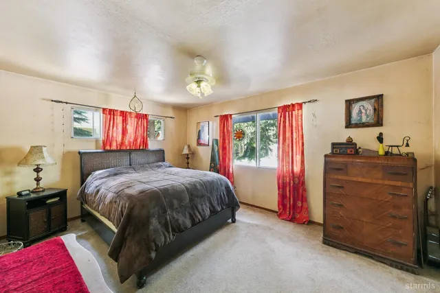 a bed room with a bed and a dresser