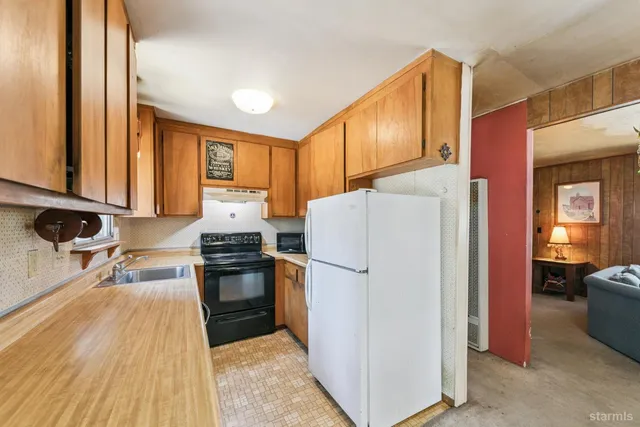 a kitchen with a refrigerator stove and sink