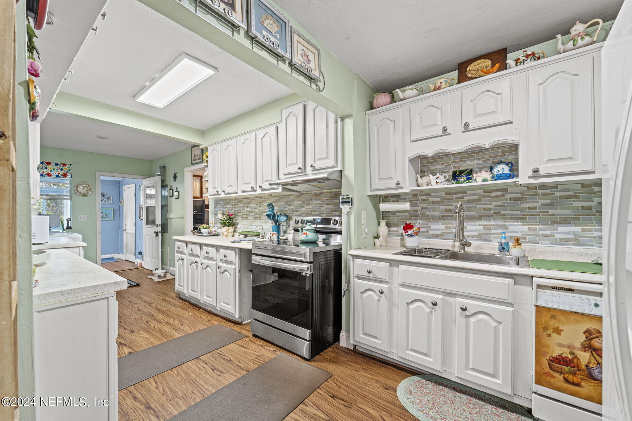2038 Reed Avenue Jacksonville, FL 32207 - Photo 13 of 43 a kitchen with stainless steel appliances granite countertop a sink a stove a refrigerator and white cabinets