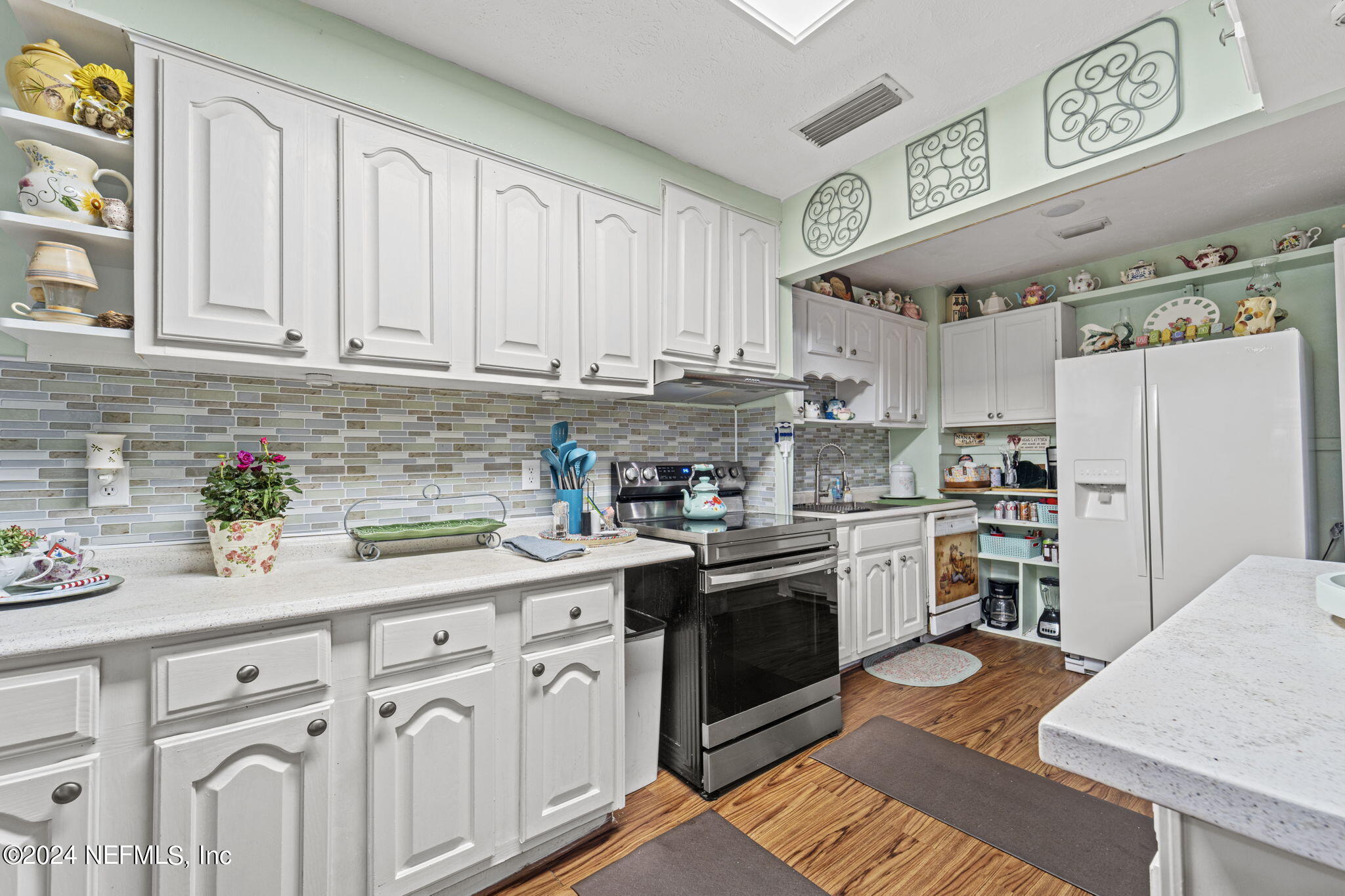 2038 Reed Avenue Jacksonville, FL 32207 - Photo 14 of 43 a kitchen with stainless steel appliances granite countertop a sink stove and cabinets