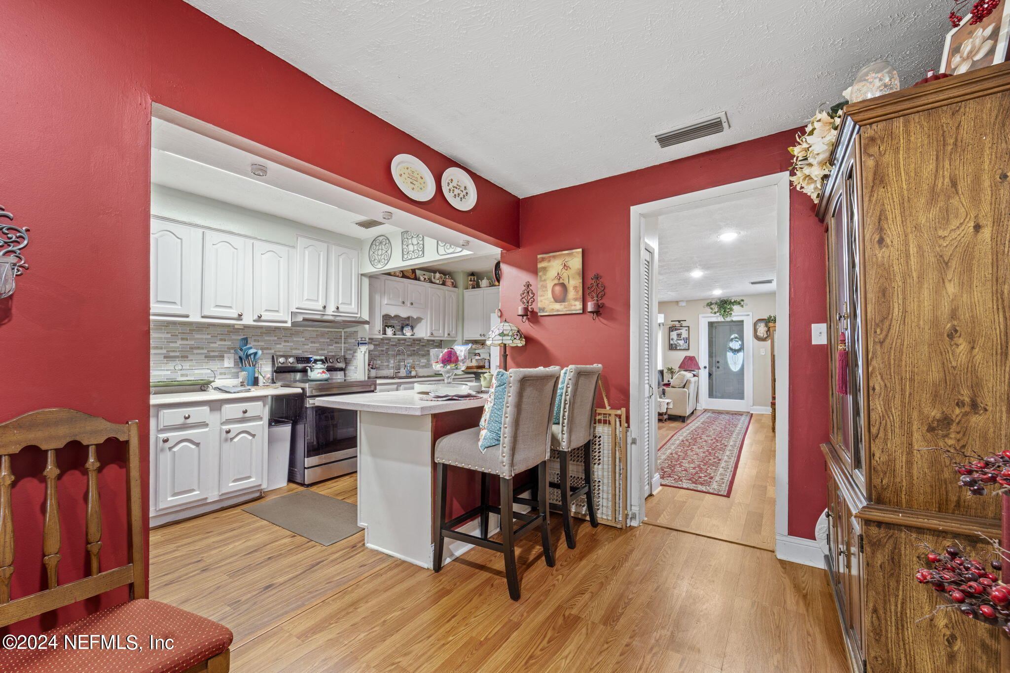 2038 Reed Avenue Jacksonville, FL 32207 - Photo 18 of 43 a kitchen with a table chairs stove and cabinets