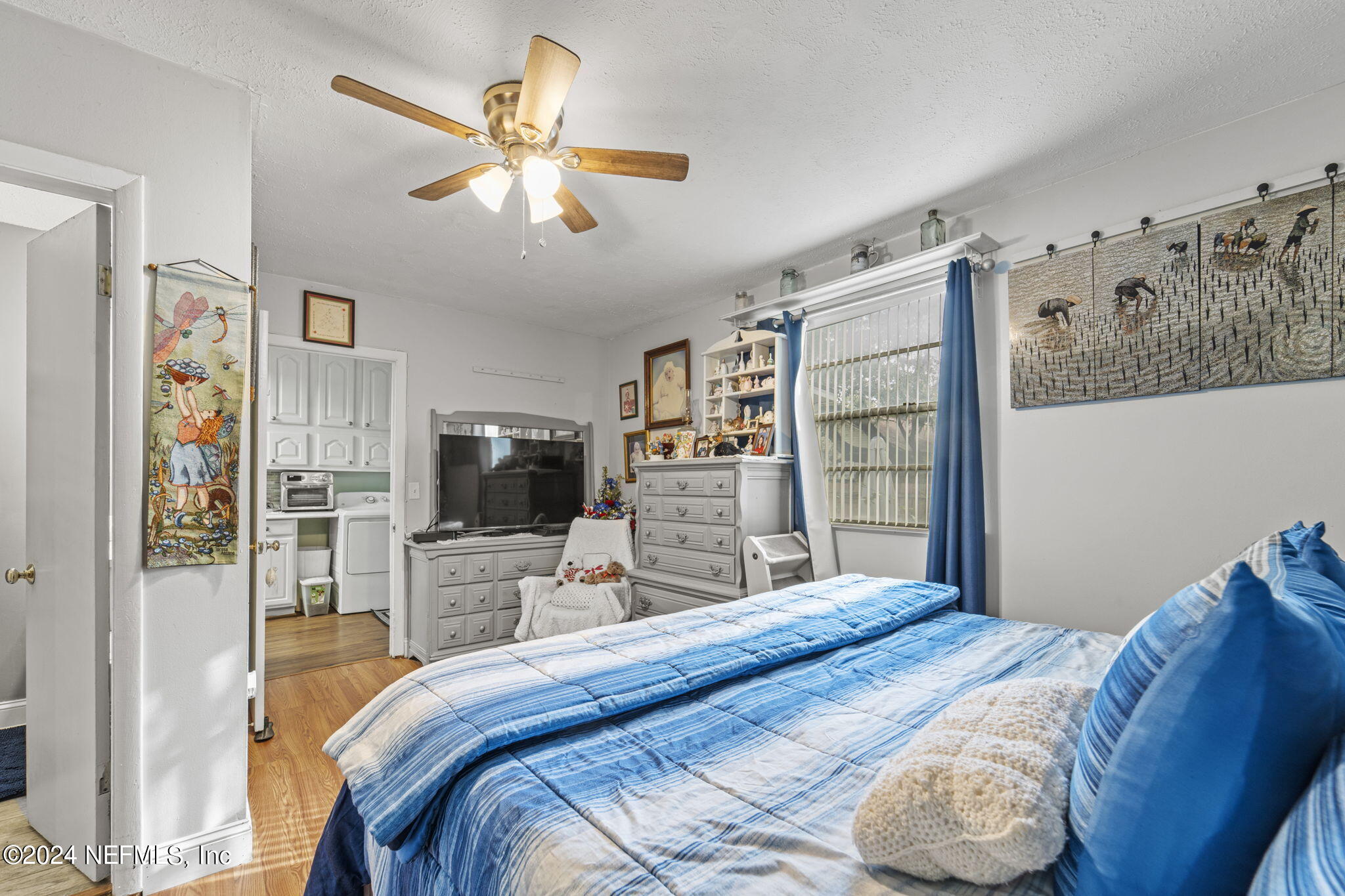 2038 Reed Avenue Jacksonville, FL 32207 - Photo 24 of 43 a bedroom with a large bed and a flat screen tv