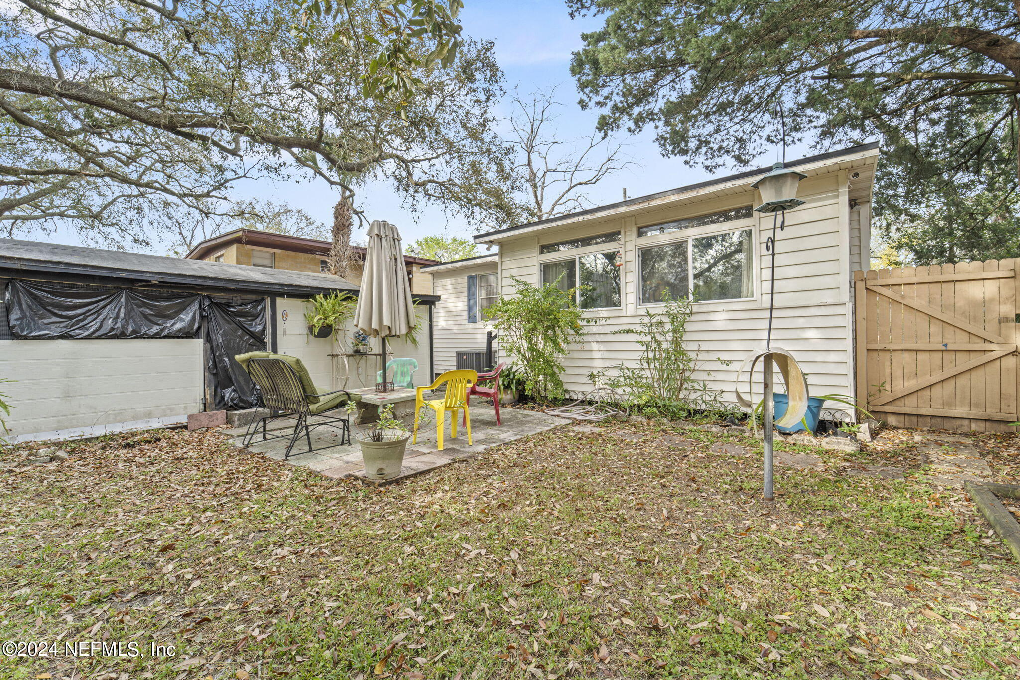2038 Reed Avenue Jacksonville, FL 32207 - Photo 35 of 43 a view of a chair and table in backyard of the house
