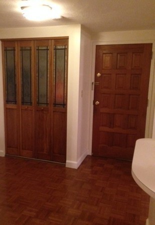 9 Broadway, Unit 217 Saugus, MA 01906 - Photo 12 of 18 an empty room with a wooden door