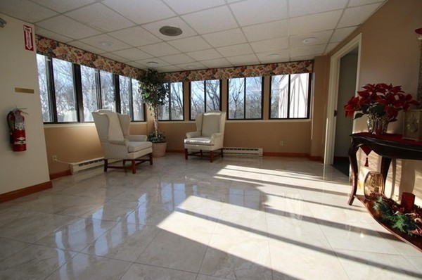 9 Broadway, Unit 217 Saugus, MA 01906 - Photo 7 of 18 a living room with furniture and a floor to ceiling window