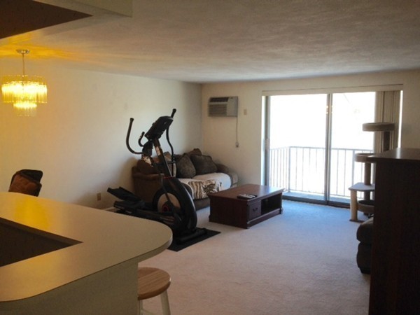 9 Broadway, Unit 217 Saugus, MA 01906 - Photo 9 of 18 a bed room with a bed and a window