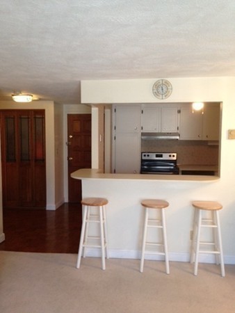 9 Broadway, Unit 217 Saugus, MA 01906 - Photo 10 of 18 a kitchen with stainless steel appliances a white cabinets and a sink