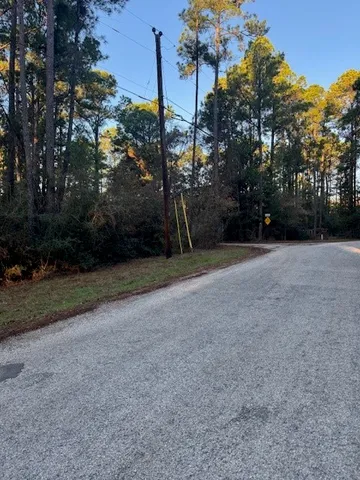 a view of a field with trees in background