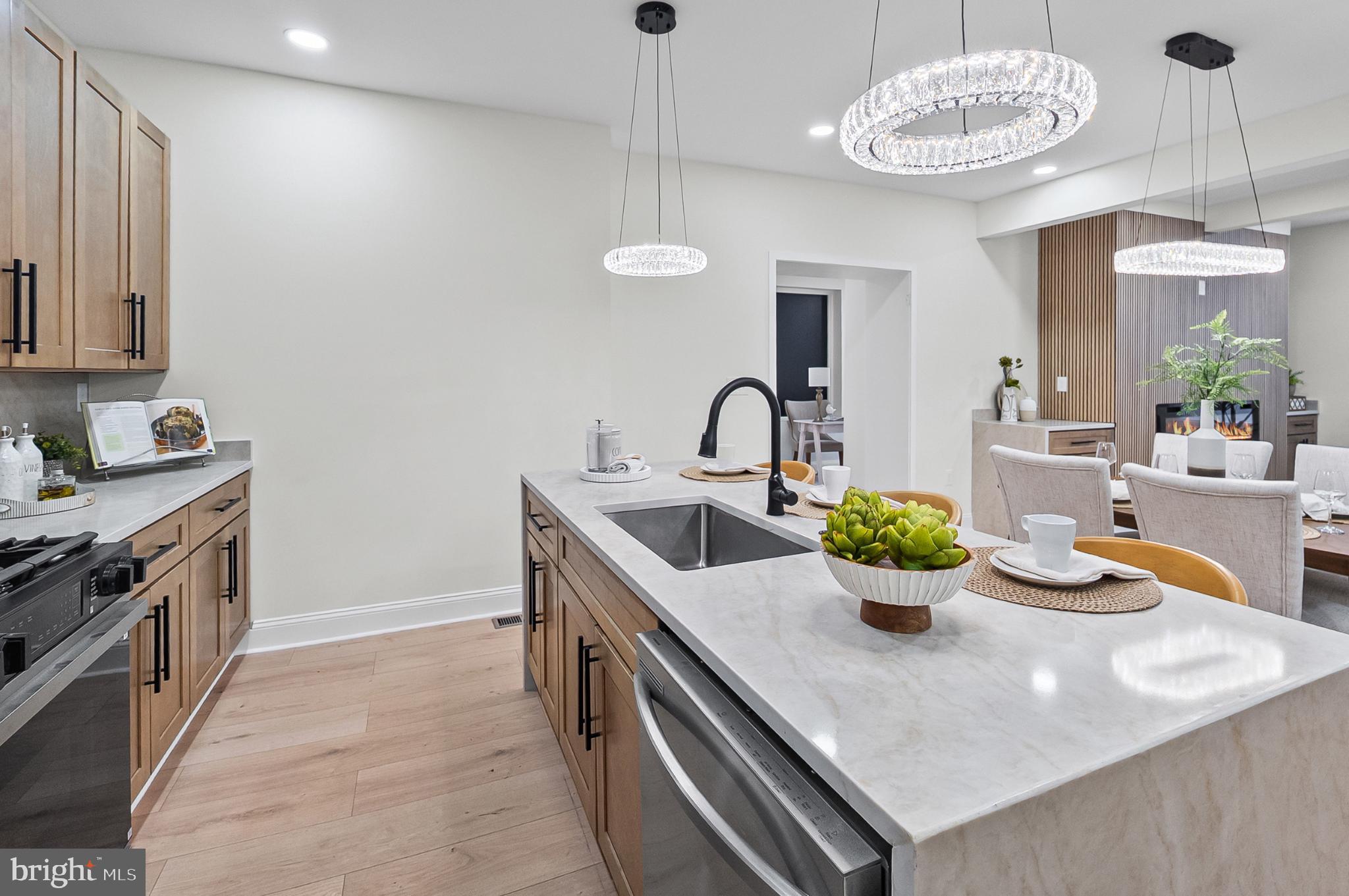 3703 Egerton Road Baltimore, MD 21215 - Photo 11 of 32 a kitchen with a stove a sink and a chandelier