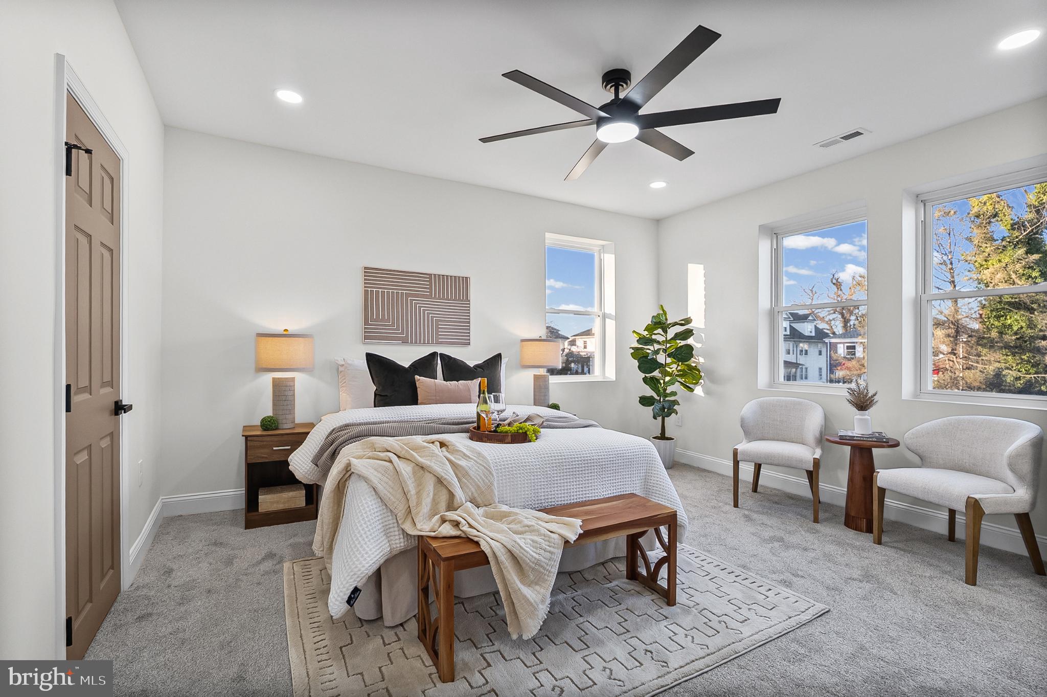 3703 Egerton Road Baltimore, MD 21215 - Photo 12 of 32 a bed room with a bed a couch and a potted plant