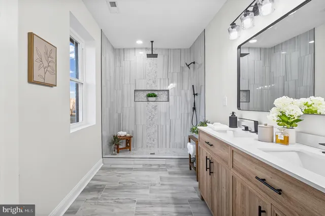 a bathroom with a sink a mirror and a shower