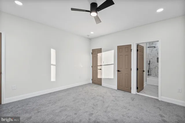 a view of empty room with ceiling fan