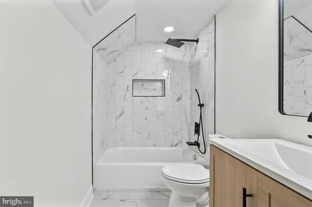 a bathroom with a sink a toilet and a bathtub