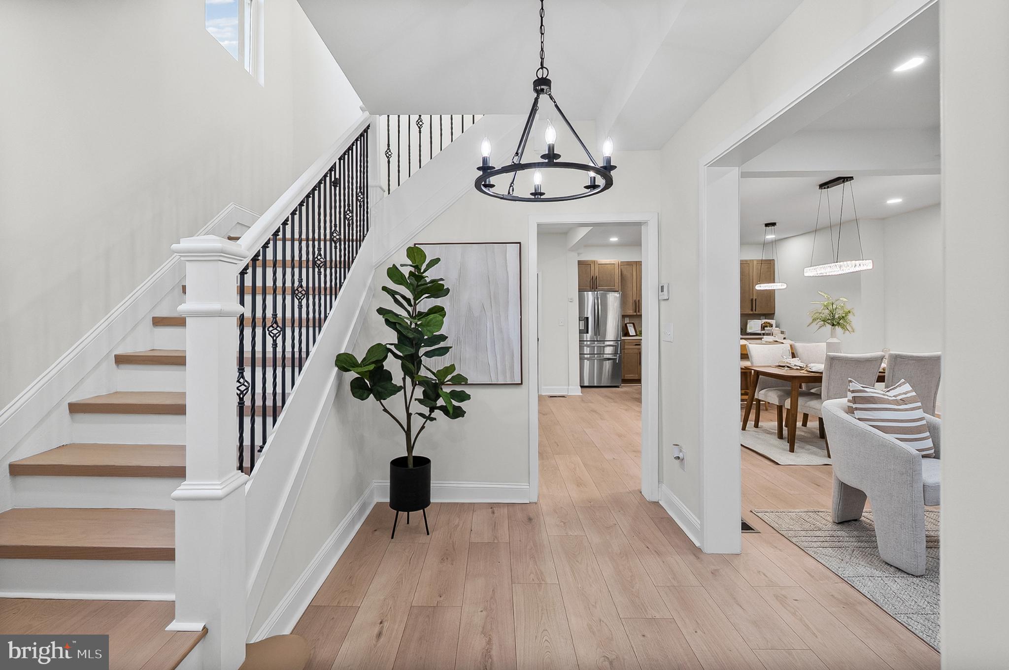 3703 Egerton Road Baltimore, MD 21215 - Photo 2 of 32 a view of a hallway with wooden floor windows and a chandelier