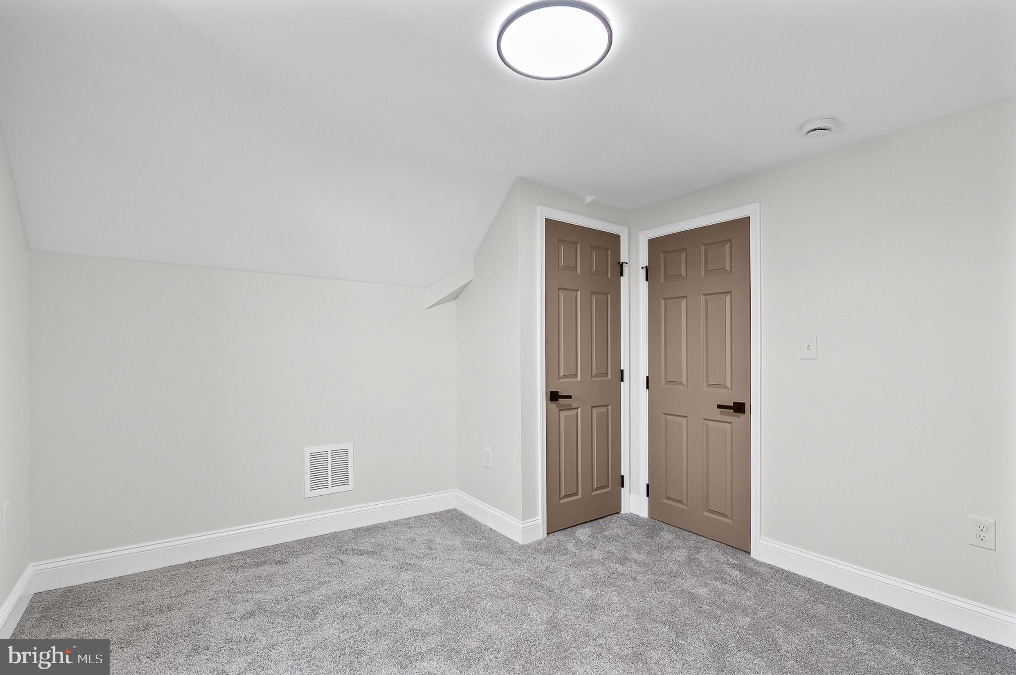 3703 Egerton Road Baltimore, MD 21215 - Photo 21 of 32 an empty room with windows