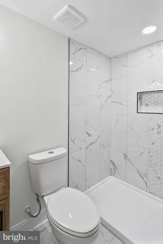 a white toilet and tub next to a bathroom sink