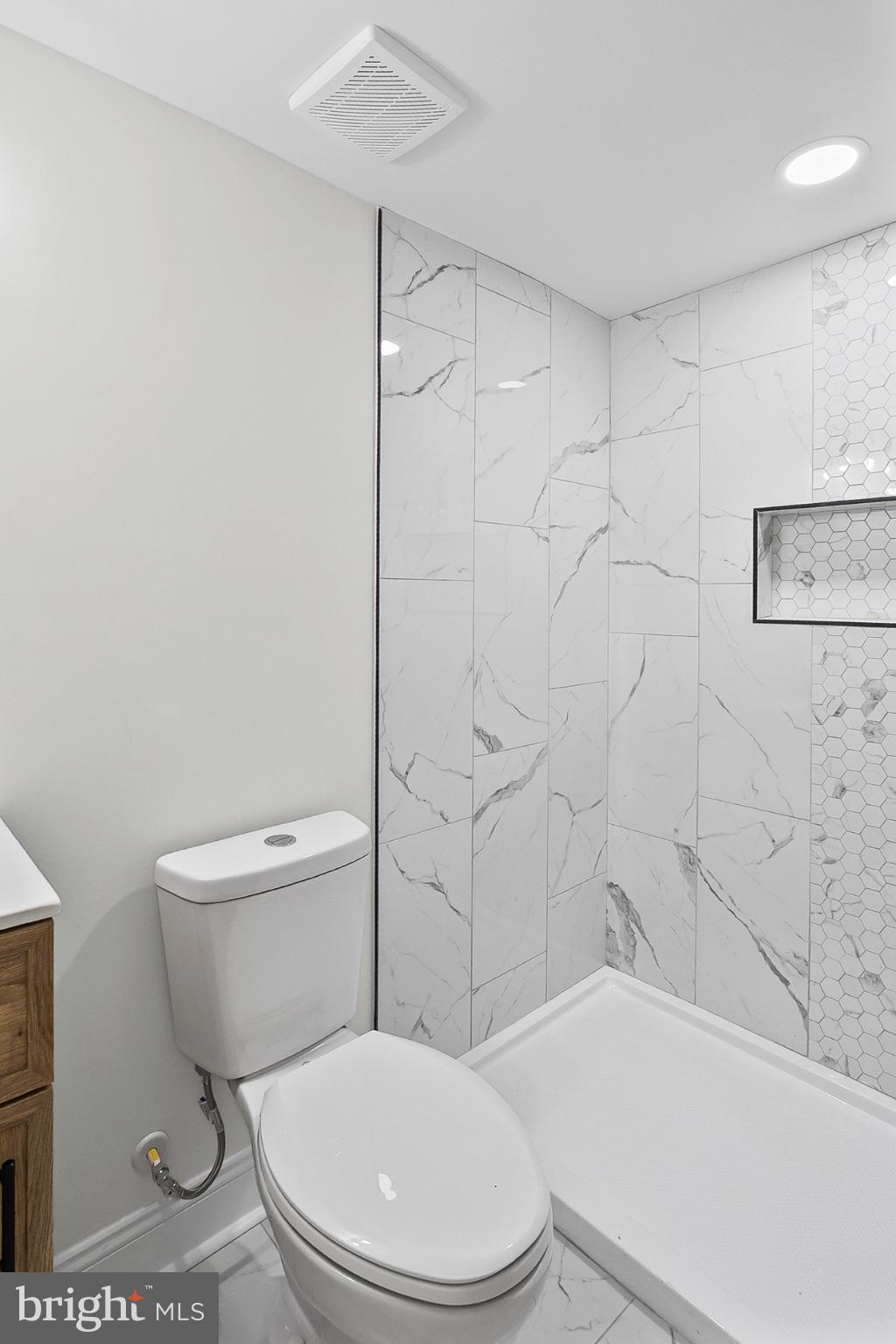 3703 Egerton Road Baltimore, MD 21215 - Photo 28 of 32 a white toilet and tub next to a bathroom sink