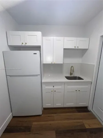 a white refrigerator freezer sitting inside of a kitchen