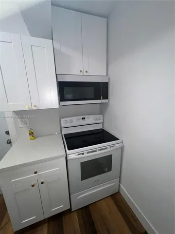 a stove top oven sitting inside of a kitchen