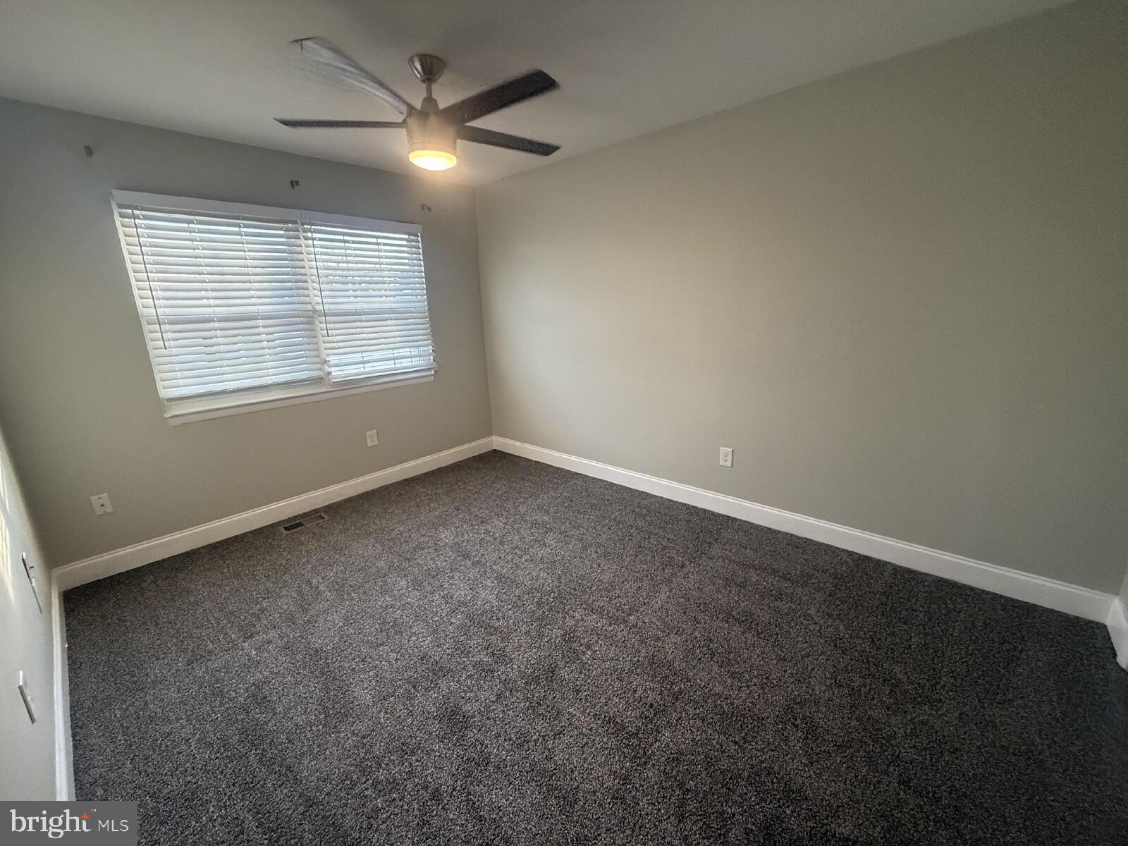 5 Bohn Court Rosedale, MD 21237 - Photo 11 of 14 an empty room with a window and a fan
