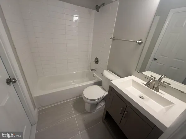 a bathroom with a sink toilet vanity and shower
