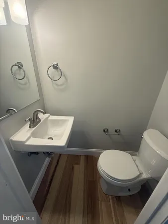 a bathroom with a sink a toilet and mirror