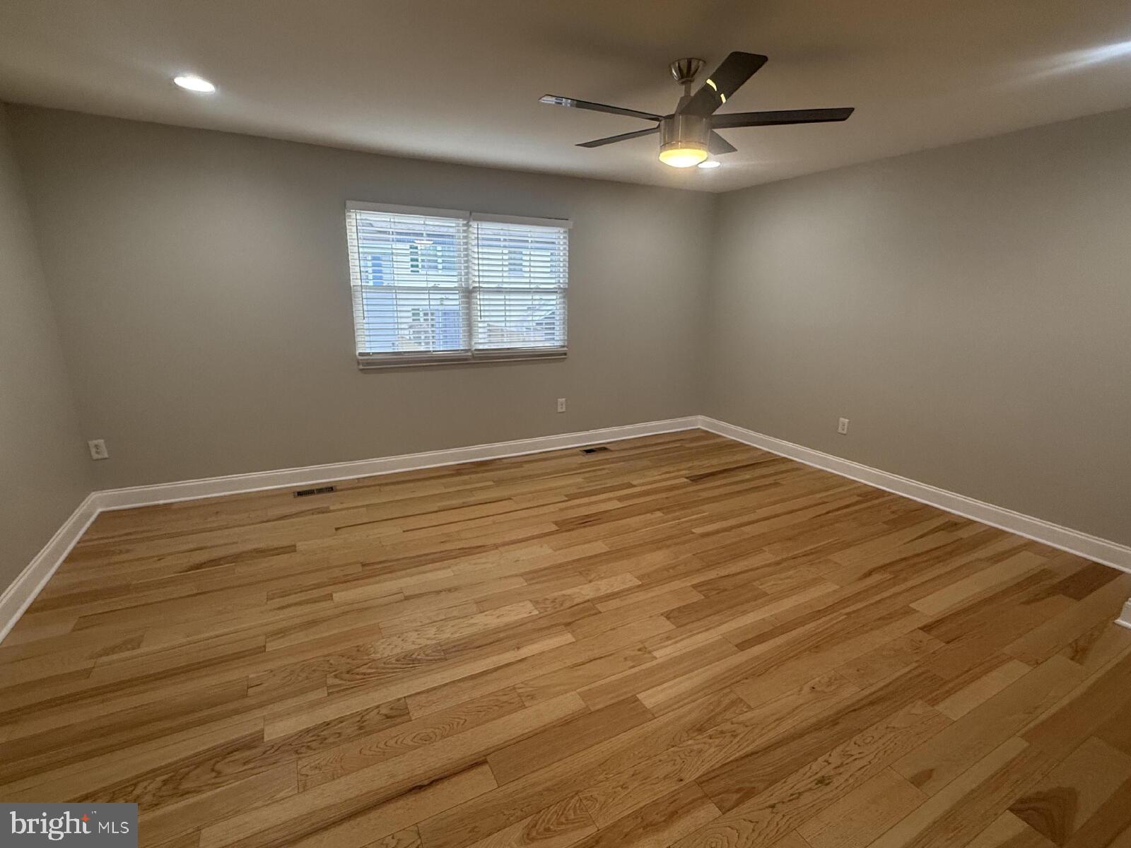 5 Bohn Court Rosedale, MD 21237 - Photo 7 of 14 an empty room with wooden floor and windows