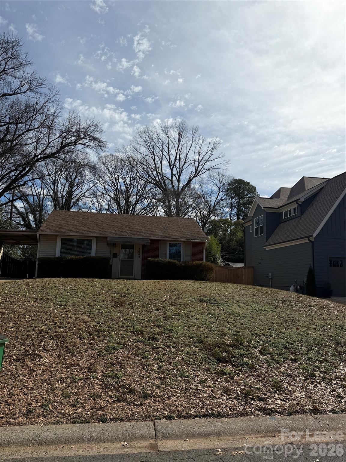 a front view of house with yard and trees