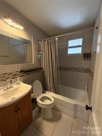 a bathroom with a toilet sink and shower