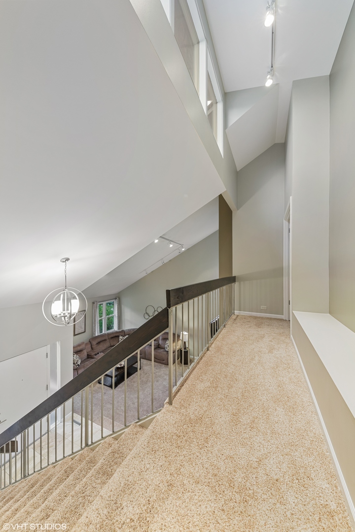 8460 Clynderven Road Burr Ridge, IL 60527 - Photo 14 of 27 a view of staircase and living room with floor to ceiling window